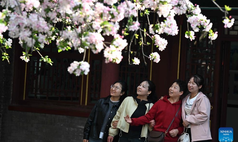 Tourists enjoy blossoms at a film and television base in Shijiazhuang, north China's Hebei Province, March 29, 2026. (Photo by Chen Qibao/Xinhua)


