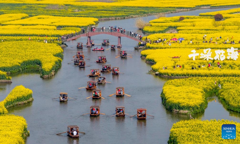 An aerial drone photo taken on March 28, 2026 shows people enjoying spring time at a scenic spot in Xinghua, east China's Jiangsu Province. (Photo by Zhou Shegen/Xinhua)

