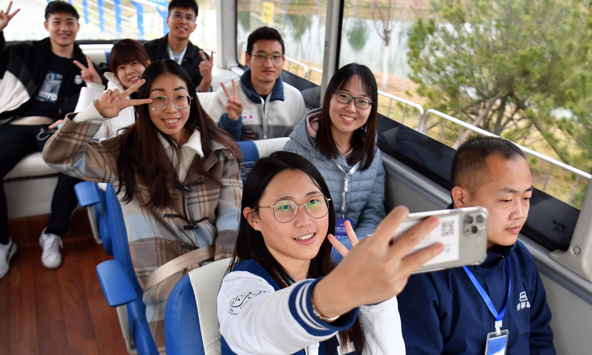 Student representatives take a test ride on an autonomous bus in Xiong'an on March 23, 2023. Photo: VCG