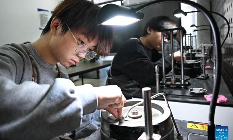 A student practices jewelry cutting and polishing at a class in Qingdao Preschool Education College in Qingdao, east China's Shandong Province, March 31, 2026.  (Xinhua/Li Ziheng)