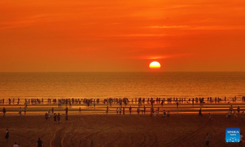 An aerial drone photo taken on Aug. 10, 2024 shows a sunrise view at a beach in Nantong, east China's Jiangsu Province. In recent years, Nantong has scaled up efforts to improve the water conservancy system, coupled with its green development endeavors in river basins and seaside areas. (Photo by Xu Congjun/Xinhua)


