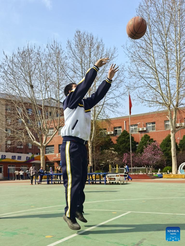 This photo taken in March 2026 shows Yangyang playing basketball at a playground in Beijing, capital of China. (Xinhua)

