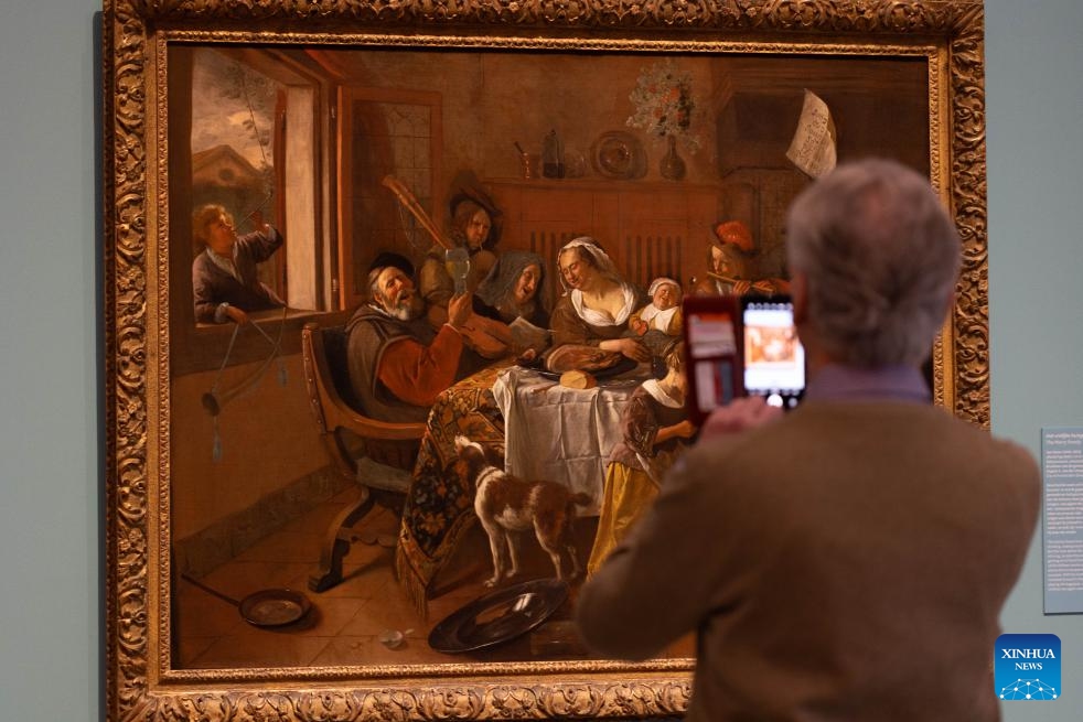 A man takes photos at the exhibition At Home with Jan Steen -- 400 Years of Merrymaking at the Museum De Lakenhal in Leiden, the Netherlands, on April 1, 2026. The exhibition will open to the public from April 2 to Aug. 23, 2026. Jan Steen was born in 1626 in Leiden and was one of the leading genre painters of the 17th century. (Photo by Sylvia Lederer/Xinhua)

