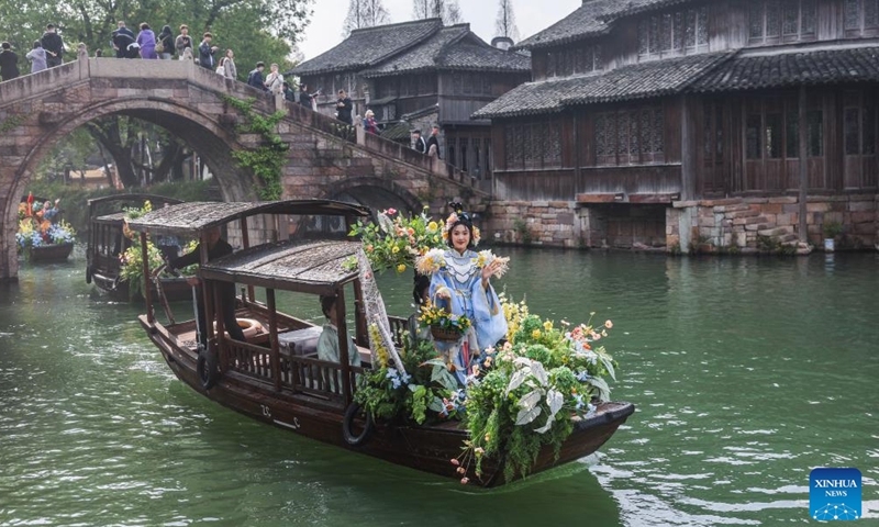 A boat parade is staged during a folk fair in Wuzhen, Tongxiang City, east China's Zhejiang Province, April 1, 2026. A folk fair opened here on Wednesday, during which people can experience the atmosphere of traditional sericulture and enjoy the spring scenery through folk parades both on the street and on the water. (Xinhua/Xu Yu)

