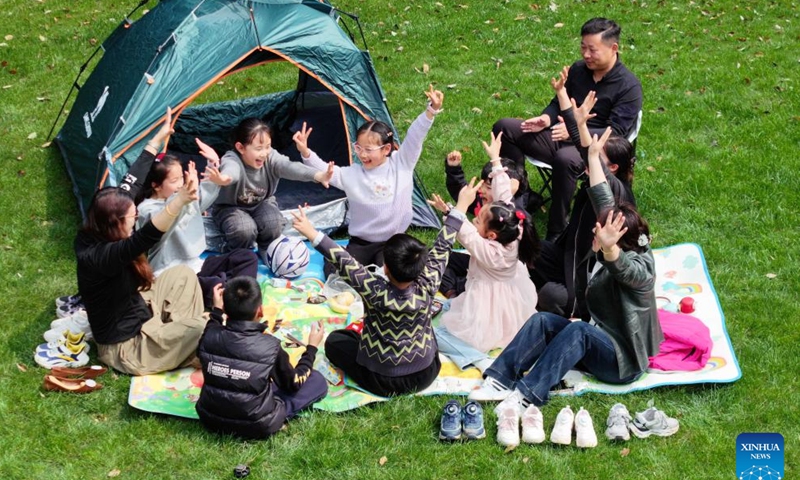An aerial drone photo taken on April 1, 2026 shows children enjoying the spring break with their families in Jurong, east China's Jiangsu Province. As spring blossoms across China, primary and secondary school students in several regions are set for their first-ever spring break, which will see them heading beyond the classroom to travel and engage in a wide range of activities. (Xinhua/Ji Chunpeng)

