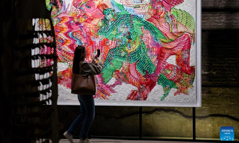 A visitor takes photos of an artwork at the exhibition Metamorphosis in Baths of Diocletian of the National Roman Museum in Rome, Italy, April 1, 2026. The exhibition presents the contemporary Chinese artist Wu Jian'an's reflection on the theme of transformation through a dialogue between Eastern and Western traditions. (Xinhua/Wang Kaiyan)

