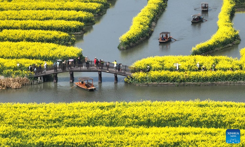 A drone photo taken on April 2, 2026 shows visitors enjoying spring time among cole flowers at a scenic area in Xinghua City, east China's Jiangsu Province. (Photo by Shi Daozhi/Xinhua)
