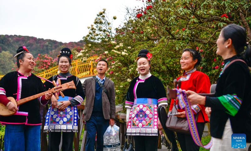 People sing a song of the Dong ethnic group at an azalea scenic area in Bijie City, southwest China's Guizhou Province, April 1, 2026. The azaleas in Bijie are currently in full bloom, drawing crowds of visitors. (Xinhua/Yang Wenbin)
