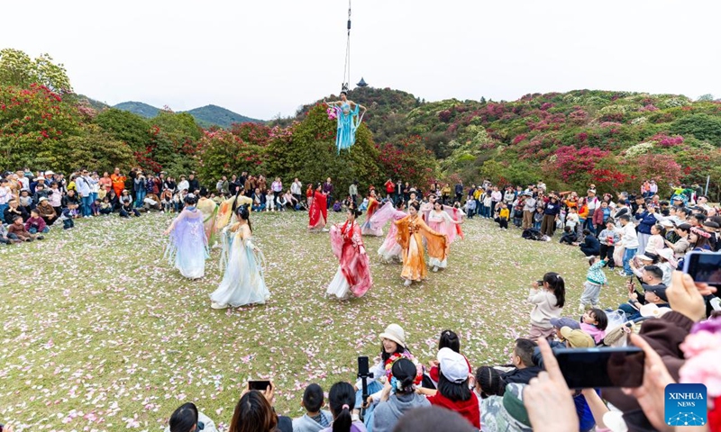 Tourists watch a performance at an azalea scenic area in Bijie City, southwest China's Guizhou Province, March 29, 2026. The azaleas in Bijie are currently in full bloom, drawing crowds of visitors. (Photo by Li Hua/Xinhua)