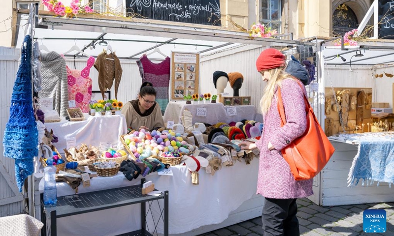 A woman visits an Easter market in Prague, the Czech Republic, April 2, 2026. As Easter approaches, a market is held in Prague's old city, attracting residents and tourists to experience the festive atmosphere. (Photo by Dana Kesnerova/Xinhua)