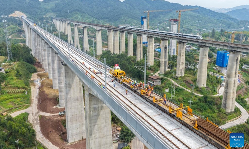 A drone photo taken on April 3, 2026 shows a construction site of the Chongqing-Wanzhou high-speed railway during its track-laying phase in southwest China's Chongqing Municipality. The construction of the Chongqing-Wanzhou high-speed railway entered the track-laying phase on Friday. With a designed speed of 350 kilometers per hour, the high-speed railway stretches 251 kilometers from Chongqing East Railway Station to Wanzhou North Railway Station. (Xinhua/Tang Yi)