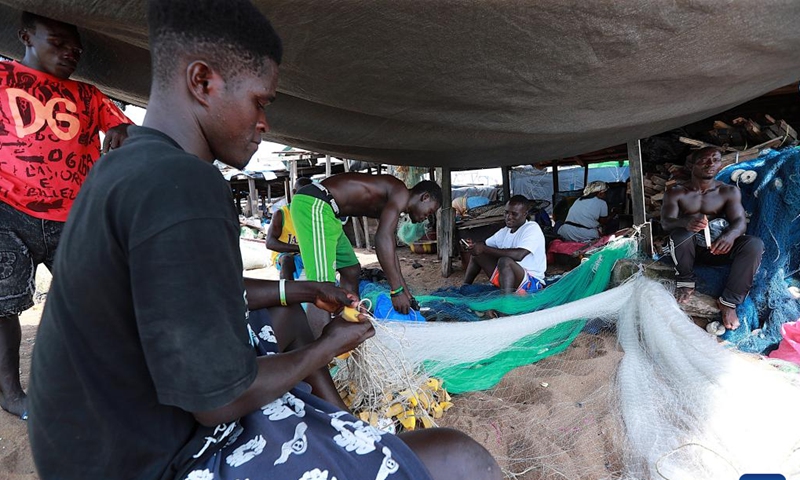Fishermen repair fishing nets on the beach in Abidjan, Cote d'Ivoire, April 3, 2026. Along the coastline of Abidjan, fishing is closely intertwined with local community life. (Photo by Yvan Sonh/Xinhua)