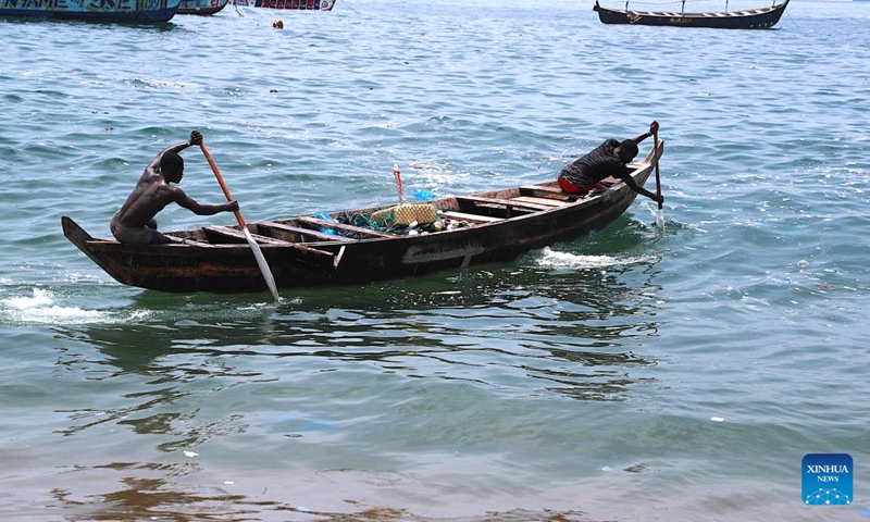 Fishermen row the boat at sea in Abidjan, Cote d'Ivoire, April 3, 2026. Along the coastline of Abidjan, fishing is closely intertwined with local community life. (Photo by Yvan Sonh/Xinhua)