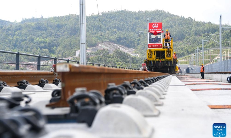 Workers carry out track-laying operations along the Chongqing-Wanzhou high-speed railway in southwest China's Chongqing Municipality, April 3, 2026. The construction of the Chongqing-Wanzhou high-speed railway entered the track-laying phase on Friday. With a designed speed of 350 kilometers per hour, the high-speed railway stretches 251 kilometers from Chongqing East Railway Station to Wanzhou North Railway Station. (Xinhua/Tang Yi)