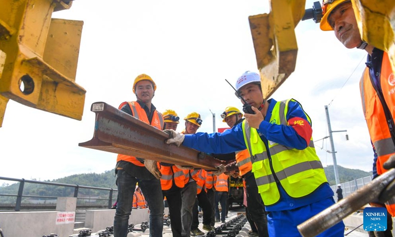 Workers carry out track-laying operations along the Chongqing-Wanzhou high-speed railway in southwest China's Chongqing Municipality, April 3, 2026. The construction of the Chongqing-Wanzhou high-speed railway entered the track-laying phase on Friday. With a designed speed of 350 kilometers per hour, the high-speed railway stretches 251 kilometers from Chongqing East Railway Station to Wanzhou North Railway Station. (Xinhua/Tang Yi)
