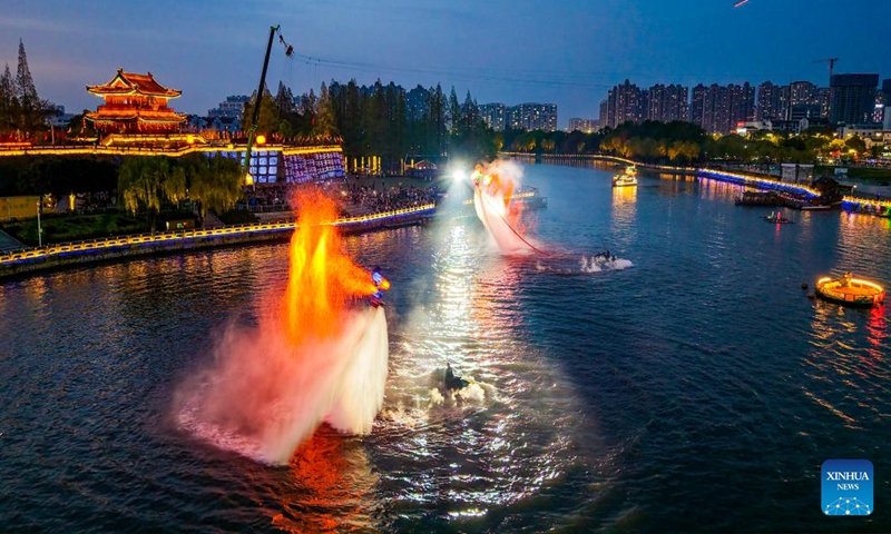 A performance is staged outside the Jingzhou ancient city in Jingzhou, central China's Hubei Province, April 3, 2026. The performance aiming at boosting spring cultural tourism was staged here on the evening of Friday, attracting lots of visitors. (Photo by Zhang Mengyao/Xinhua)