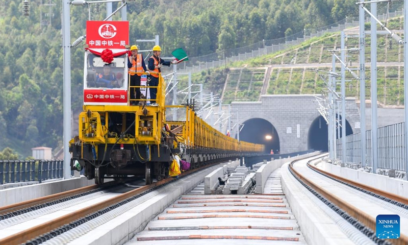 Workers carry out track-laying operations along the Chongqing-Wanzhou high-speed railway in southwest China's Chongqing Municipality, April 3, 2026. The construction of the Chongqing-Wanzhou high-speed railway entered the track-laying phase on Friday. With a designed speed of 350 kilometers per hour, the high-speed railway stretches 251 kilometers from Chongqing East Railway Station to Wanzhou North Railway Station. (Xinhua/Tang Yi)