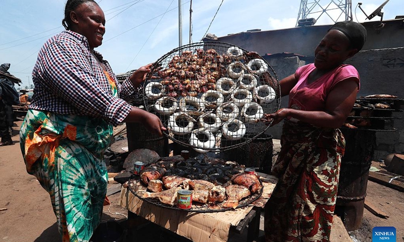 Women process smoked fish in Abidjan, Cote d'Ivoire, April 3, 2026. Along the coastline of Abidjan, fishing is closely intertwined with local community life. (Photo by Yvan Sonh/Xinhua)
