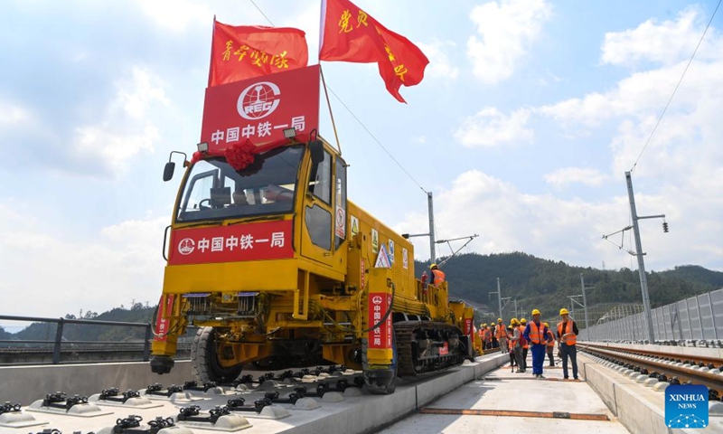 Workers carry out track-laying operations along the Chongqing-Wanzhou high-speed railway in southwest China's Chongqing Municipality, April 3, 2026. The construction of the Chongqing-Wanzhou high-speed railway entered the track-laying phase on Friday. With a designed speed of 350 kilometers per hour, the high-speed railway stretches 251 kilometers from Chongqing East Railway Station to Wanzhou North Railway Station. (Xinhua/Tang Yi)