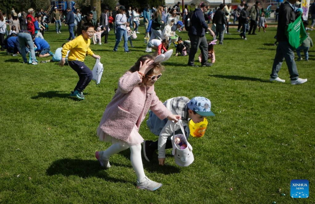 Children take part in an egg hunt during the annual Easter Parade at Ladner Village in Delta, British Columbia, Canada, on April 5, 2026. The annual Easter event, a community tradition of more than 60 years, featured a festive parade and family-oriented activities, drawing local residents to celebrate the holiday. (Photo by Liang Sen/Xinhua)