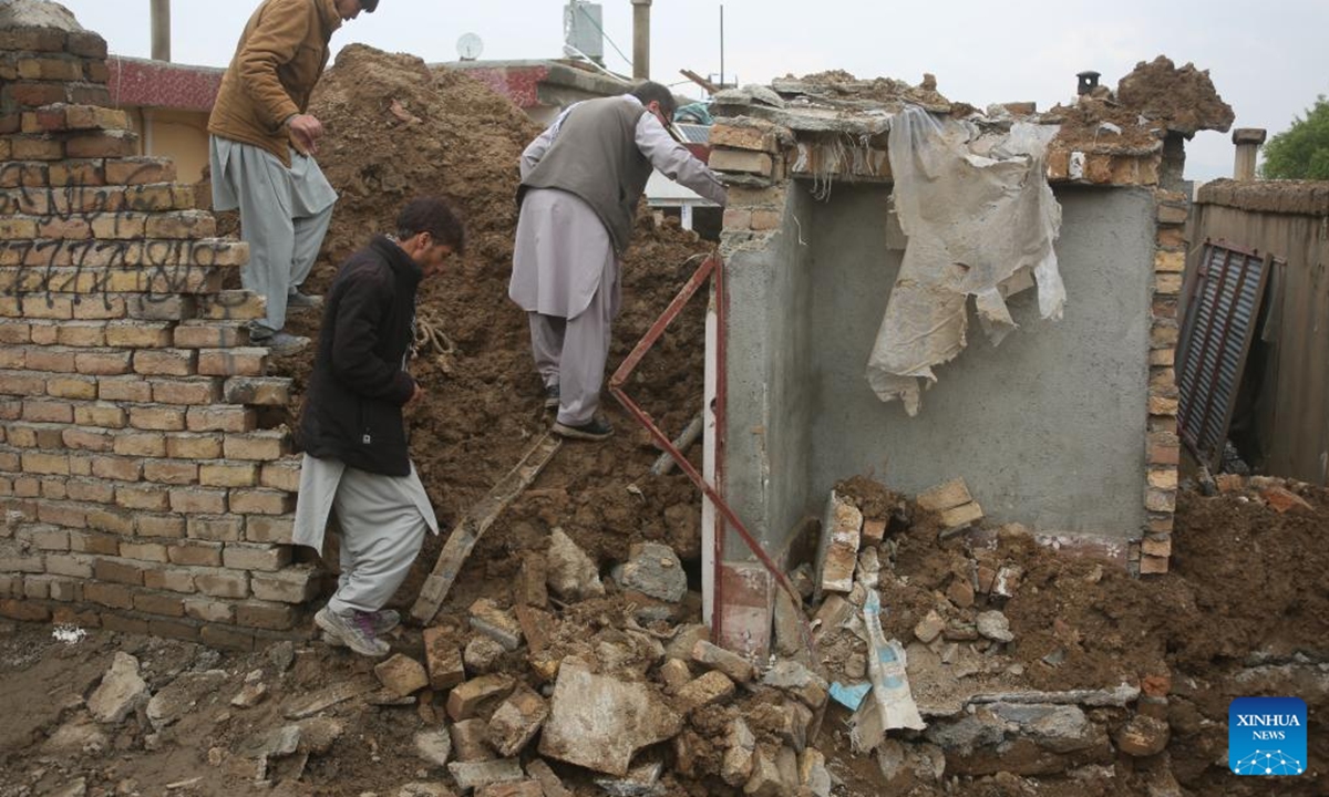 People check damage after a house has collapsed during heavy rains in Kabul, capital of Afghanistan, April 5, 2026. The death toll from heavy rainfall-triggered flooding across Afghanistan has risen to at least 99 people, with 154 others injured over the past nine days, a spokesman for the National Disaster Management Authority said on Sunday. (Photo by Saifurahman Safi/Xinhua)