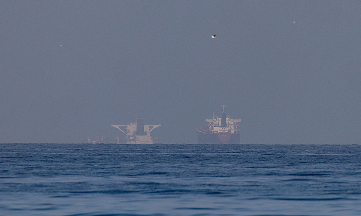 Commercial vessels are seen in the Gulf, near the Strait of Hormuz on March 22, 2026 in northern Ras al Khaimah, United Arab Emirates. Photo: VCG