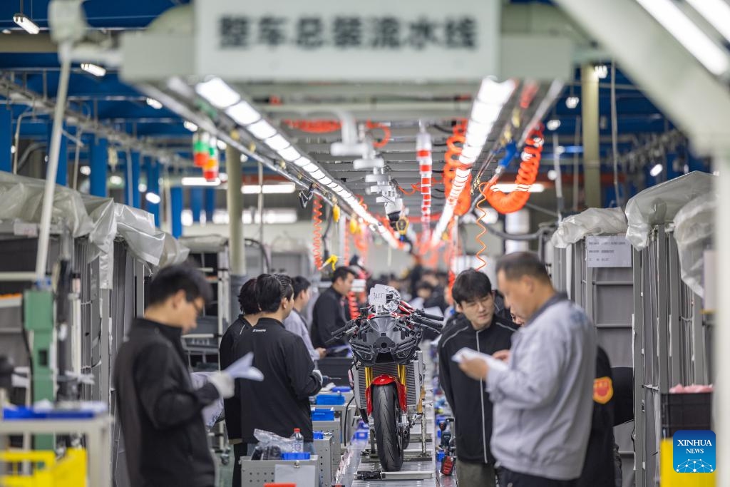 Employees work on an assembly line at the production workshop of ZXMOTO in Liangjiang New Area, southwest China's Chongqing, on April 1, 2026. (Xinhua/Huang Wei)