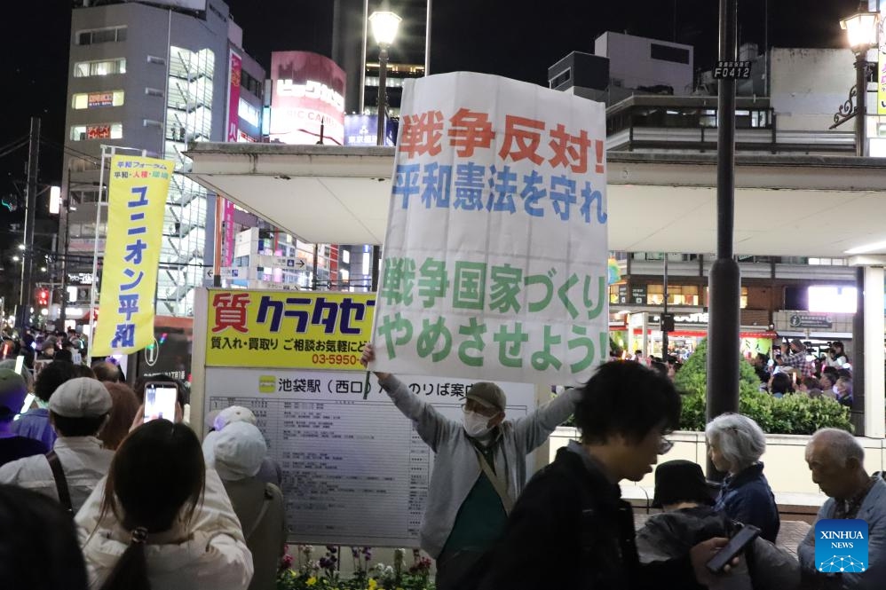 People participate in a protest outside the Ikebukuro station in Tokyo, Japan, on April 5, 2026. (Xinhua/Li Ziyue)
