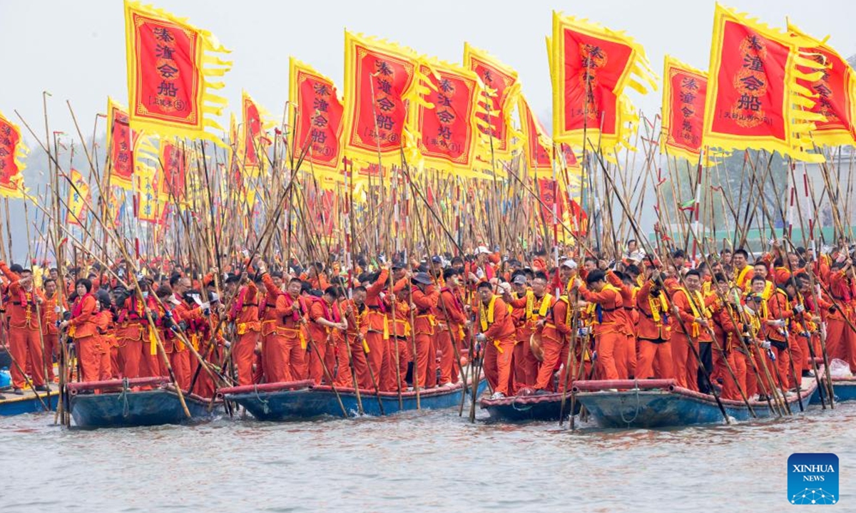 Boatmen pole boats forward to compete during the Qintong Boat Festival held at the Qinhu National Wetland Park in Qintong Town of Taizhou City, east China's Jiangsu Province, on April 6, 2026. Originating in ancient China's Southern Song Dynasty (1127-1279), the Qintong Boat Festival has been said to be held in memory of ancestors and ancient heroes. Hundreds of boats with more than 10,000 polers aboard gathered here on Monday for this year's festival, during which each boat competed in a speed challenge. (Photo by Tang Dehong/Xinhua)