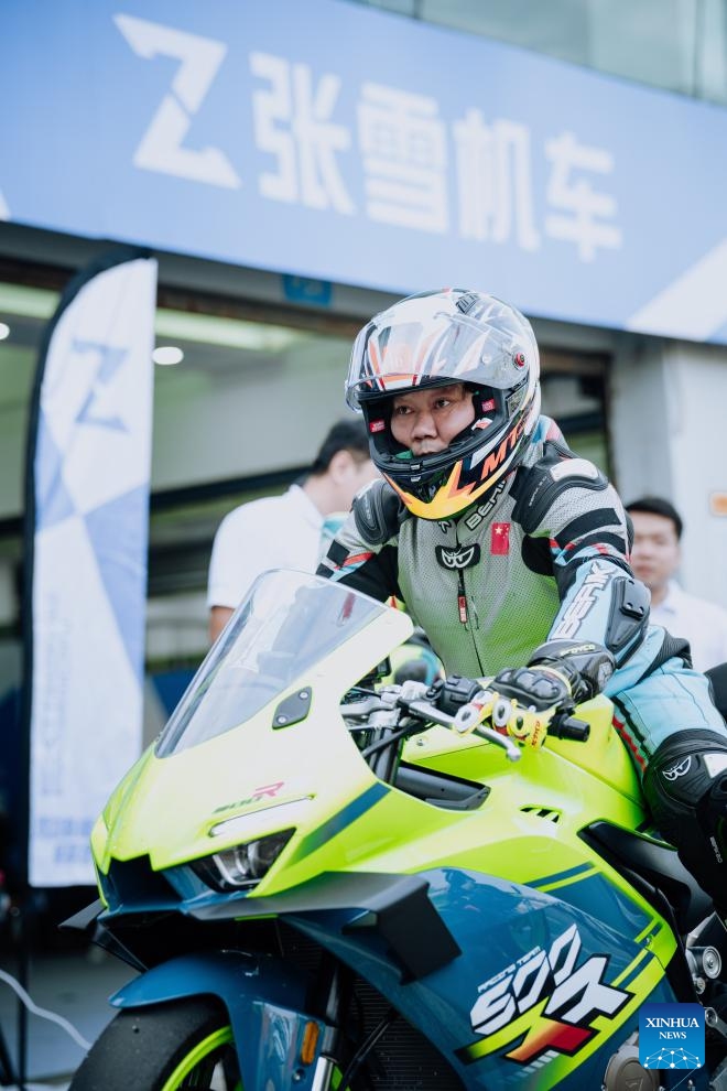 Zhang Xue (front) test-drives a motorcycle at Zhuhai International Circuit in Zhuhai, south China's Guangdong Province, on Jan. 16, 2025. (Xinhua)