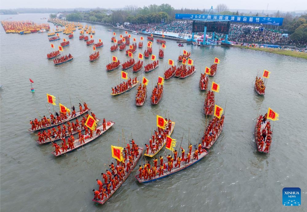 A drone photo taken on April 6, 2026 shows boats competing during the Qintong Boat Festival held at the Qinhu National Wetland Park in Qintong Town of Taizhou City, east China's Jiangsu Province. Originating in ancient China's Southern Song Dynasty (1127-1279), the Qintong Boat Festival has been said to be held in memory of ancestors and ancient heroes. Hundreds of boats with more than 10,000 polers aboard gathered here on Monday for this year's festival, during which each boat competed in a speed challenge. (Photo by Tang Dehong/Xinhua)