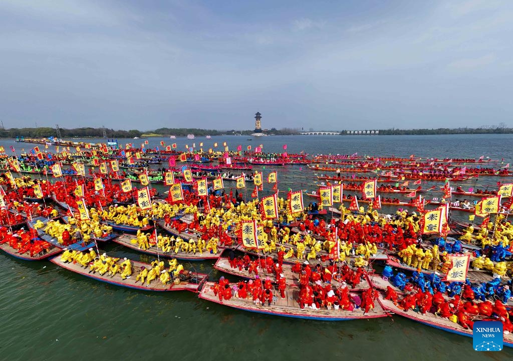 A drone photo taken on April 6, 2026 shows boats competing during the Qintong Boat Festival held at the Qinhu National Wetland Park in Qintong Town of Taizhou City, east China's Jiangsu Province. Originating in ancient China's Southern Song Dynasty (1127-1279), the Qintong Boat Festival has been said to be held in memory of ancestors and ancient heroes. Hundreds of boats with more than 10,000 polers aboard gathered here on Monday for this year's festival, during which each boat competed in a speed challenge. (Photo by Tang Dehong/Xinhua)