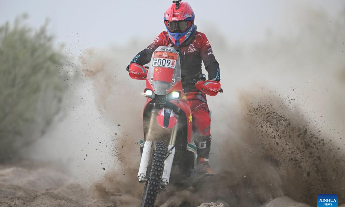Zhang Xue competes during the 2023 Taklimakan Rally in Minfeng County of Hotan Prefecture, northwest China's Xinjiang Uygur Autonomous Region, on May 30, 2023. Recently, a video went viral among Chinese motorcycling fans on social media, showing a brightly painted ZXMOTO motorcycle thundering past the finish line with an impressive lead of nearly four seconds. Thousands of miles away in southwest China's Chongqing, Zhang Xue stared at the live broadcast with tears running down his face. He had spent 20 years preparing for that moment. (Xinhua/Hu Huhu)