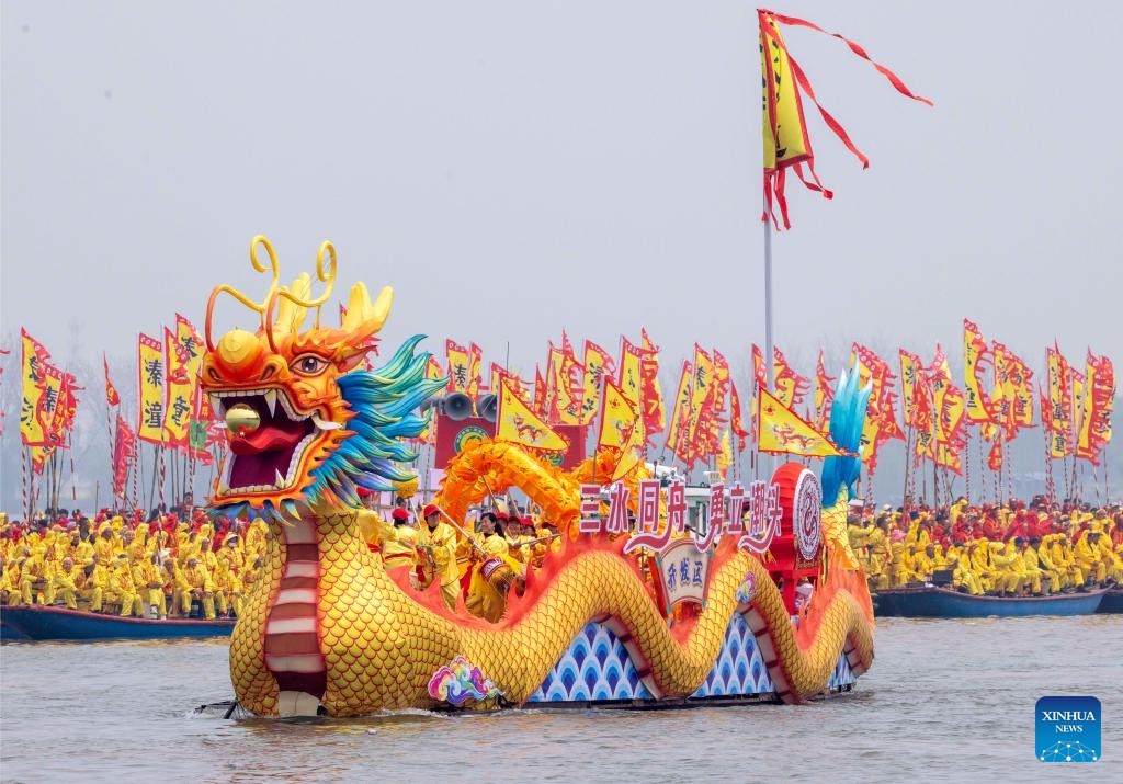 A dragon boat takes part in the Qintong Boat Festival held at the Qinhu National Wetland Park in Qintong Town of Taizhou City, east China's Jiangsu Province, April 6, 2026. Originating in ancient China's Southern Song Dynasty (1127-1279), the Qintong Boat Festival has been said to be held in memory of ancestors and ancient heroes. Hundreds of boats with more than 10,000 polers aboard gathered here on Monday for this year's festival, during which each boat competed in a speed challenge. (Photo by Tang Dehong/Xinhua)