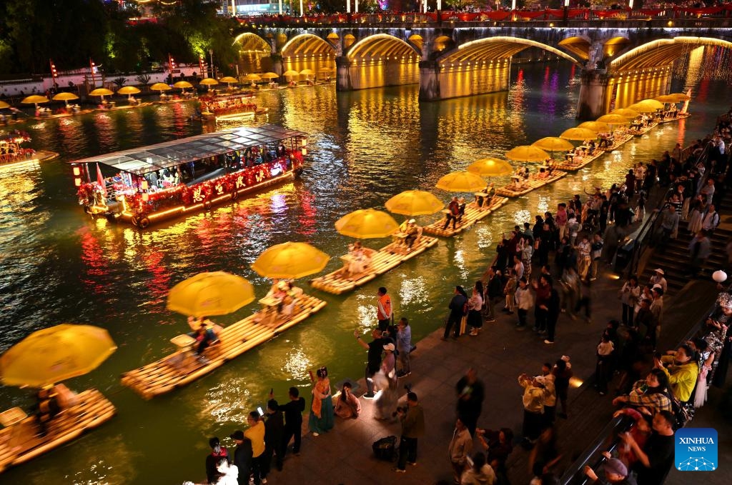 Tourists take bamboo rafts to enjoy the view on a river in Xuan'en County, central China's Hubei Province, on April 4, 2026. China recorded 135 million domestic tourist trips during the three-day Qingming Festival holiday, up 6.8 percent from a year earlier, while tourism spending rose 6.6 percent to nearly 61.37 billion yuan (8.9 billion U.S. dollars), according to the Ministry of Culture and Tourism on Tuesday. (Photo by Song Wen/Xinhua)