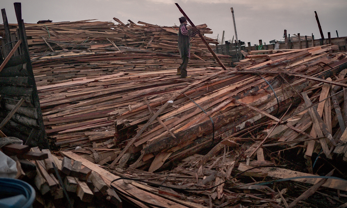 A worker sorts a pile of wood to be made into charcoal at a small-scale factory on April 8, 2026 in Johor, Malaysia. The reliance on imported crude, particularly shipments passing through the Strait of Hormuz, exposes the country to supply risks when tensions escalate in the region, according to media reports. Photo: VCG