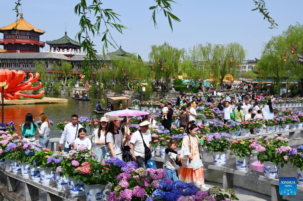 Tourists visit the Hanyuan Stele Forest cultural garden in Kaifeng City, central China's Henan Province, on April 5, 2026. China recorded 135 million domestic tourist trips during the three-day Qingming Festival holiday, up 6.8 percent from a year earlier, while tourism spending rose 6.6 percent to nearly 61.37 billion yuan (8.9 billion U.S. dollars), according to the Ministry of Culture and Tourism on Tuesday. (Photo by Li Junsheng/Xinhua)