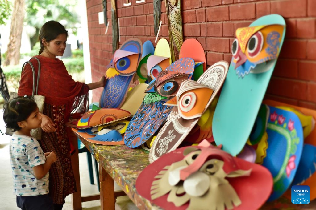 People view artworks before Bengali New Year, or Pahela Baishakh, at the Faculty of Fine Arts of University of Dhaka in Dhaka, Bangladesh, April 6, 2026. (Photo by Habibur Rahman/Xinhua)