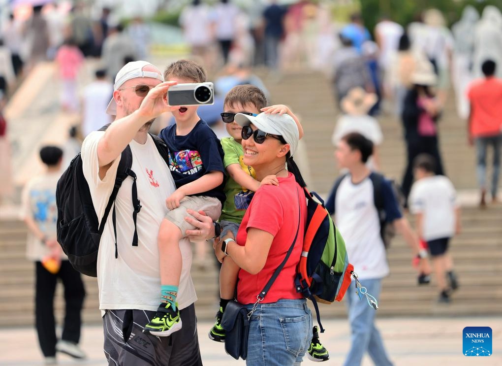 Tourists take a selfie while visiting the Nanshan Cultural Tourism Zone in Sanya City, south China's Hainan Province, on April 6, 2026. China recorded 135 million domestic tourist trips during the three-day Qingming Festival holiday, up 6.8 percent from a year earlier, while tourism spending rose 6.6 percent to nearly 61.37 billion yuan (8.9 billion U.S. dollars), according to the Ministry of Culture and Tourism on Tuesday. (Photo by Chen Wenwu/Xinhua)