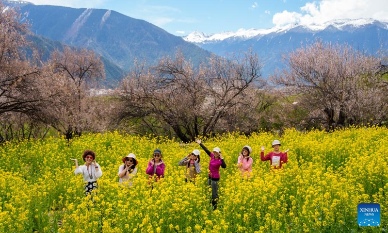 Tourists pose for photos in Galai Village of Nyingchi City, southwest China's Xizang Autonomous Region, April 2, 2026.(Xinhua/Tenzin Nyida)