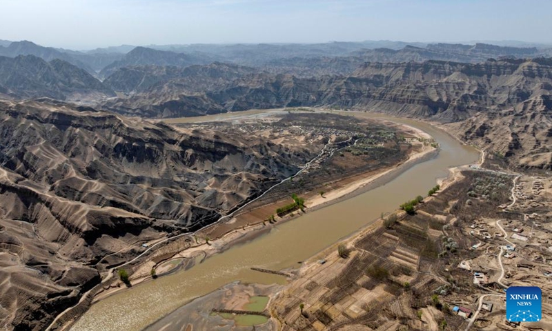 An aerial drone photo taken on April 6, 2026 shows a view of the Nanchangtan Village in Zhongwei City, northwest China's Ningxia Hui Autonomous Region. Nanchangtan nestles in a crescent-shaped riverbank area, where the Yellow River, China's second-longest river, flows through when entering Ningxia. (Xinhua/Wang Peng)
