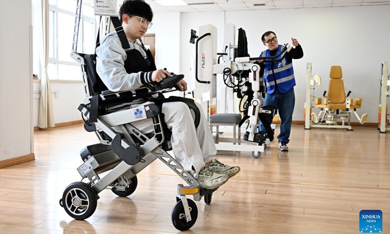 Staff members test walking assistance robots at Qingdao Training Center for Elderly Care Robots in Qingdao, east China's Shandong Province, April 9, 2026. (Xinhua/Li Ziheng)

