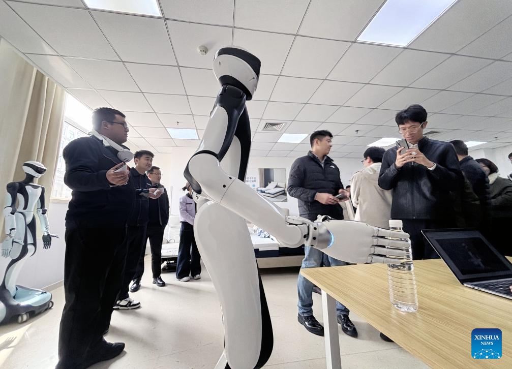 This photo taken by a cellphone on March 18, 2026 shows people visiting the Qingdao Training Center for Elderly Care Robots in Qingdao, east China's Shandong Province. (Xinhua)