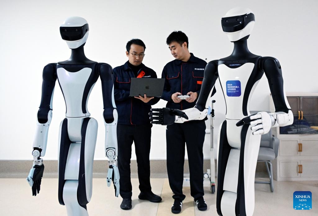 Staff members train robots at Qingdao Training Center for Elderly Care Robots in Qingdao, east China's Shandong Province, April 9, 2026. (Xinhua/Li Ziheng)

