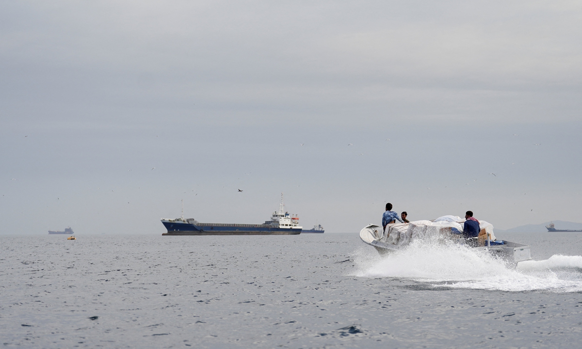 Vessels sail at the Strait of Hormuz, off the coast of Oman's Musandam province on April 12, 2026. Photo: IC