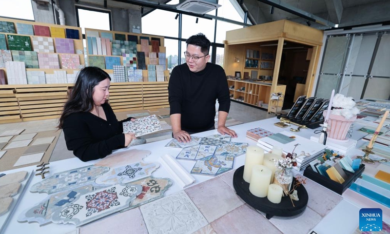 Zhu Xiaodong (R) designs tiles at a workshop in Yuxin Town, Nanhu District of Jiaxing City, east China's Zhejiang Province, April 8, 2026. (Xinhua/Xu Yu)