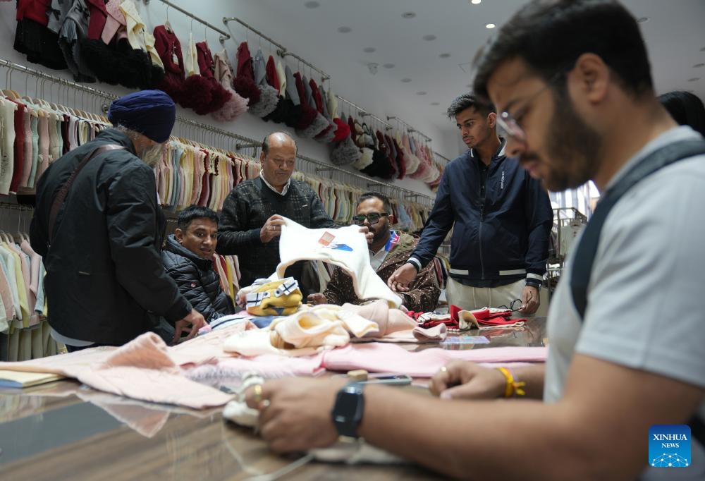 Indian clients select products at a children's clothing market in Zhili Town, Huzhou City of east China's Zhejiang Province, April 13, 2026.