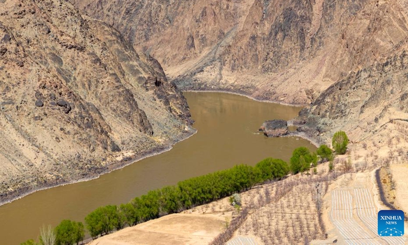 An aerial drone photo taken on April 6, 2026 shows trees turning green in Nanchangtan Village of Zhongwei City, northwest China's Ningxia Hui Autonomous Region. Nanchangtan nestles in a crescent-shaped riverbank area, where the Yellow River, China's second-longest river, flows through when entering Ningxia. (Xinhua/Wang Peng)