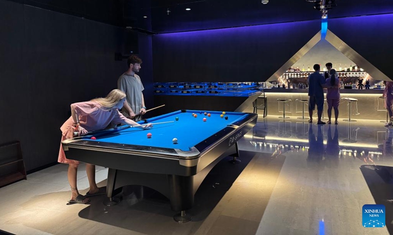 Foreign tourists play pool at a hot spring resort in Shanghai, east China, April 3, 2026. (Xinhua/Huang Anqi)

