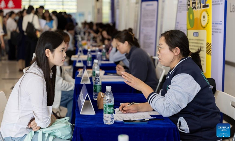 A job seeker talks with a recruiter at a job fair on Songjiang campus of Shanghai University of Engineering Science in east China's Shanghai, April 9, 2026. The job fair for the elderly care service was held here on Thursday. Nearly 50 organizations and enterprises offered over a hundred opportunities. (Xinhua/Wang Xiang)

